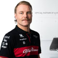 Valtteri Bottas stands near his Alfa Romeo F1 car.